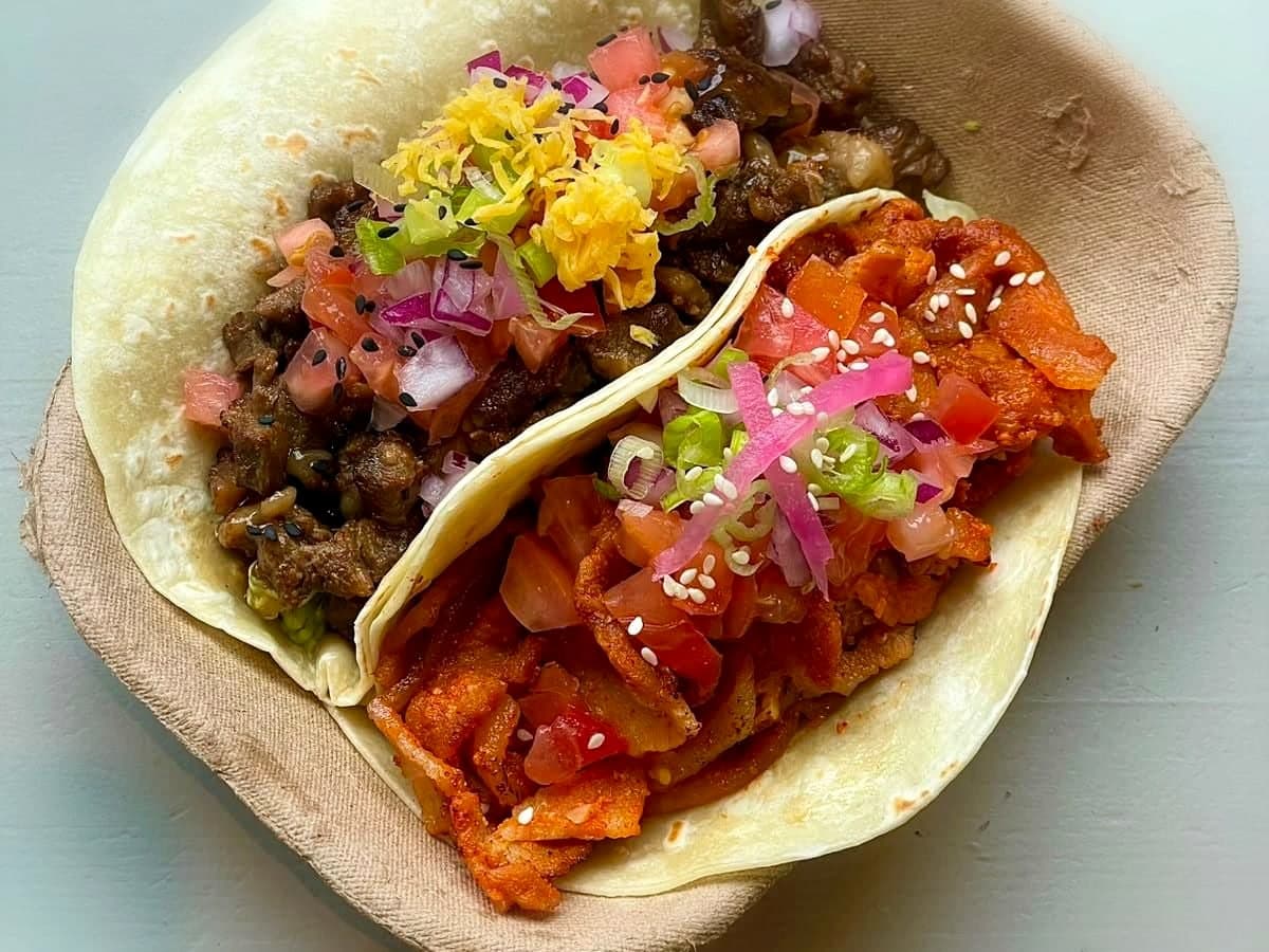 Two tacos — grilled beef belly and spicy pork belly